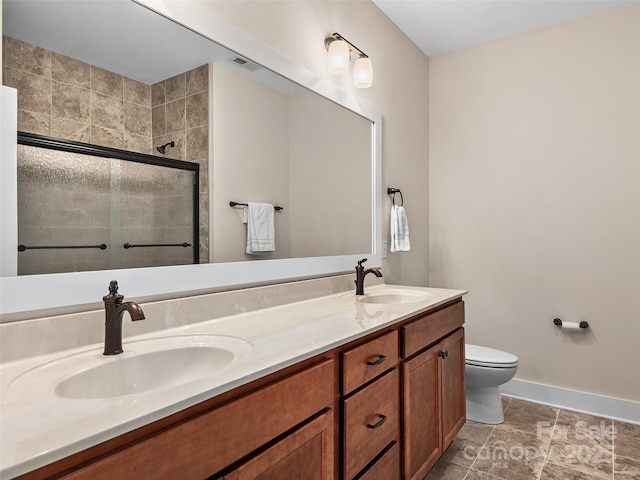 bathroom featuring toilet, an enclosed shower, and vanity