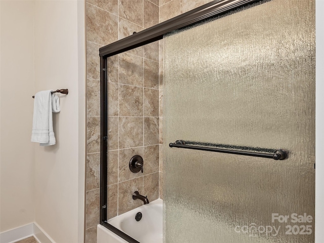 bathroom with combined bath / shower with glass door