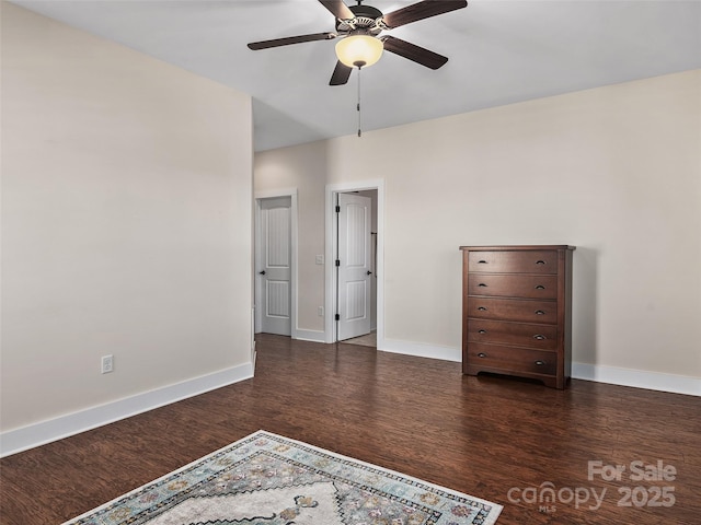 unfurnished bedroom with ceiling fan and dark hardwood / wood-style flooring