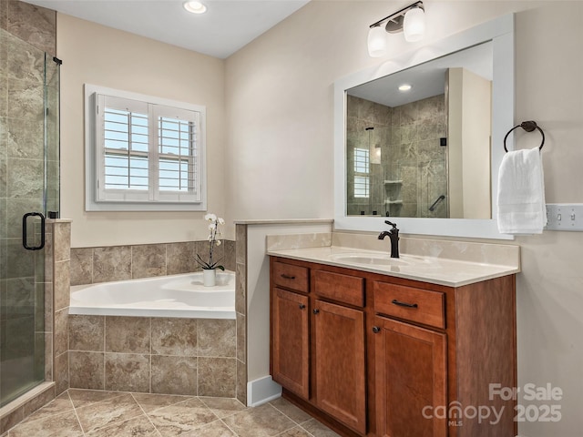 bathroom featuring vanity and independent shower and bath