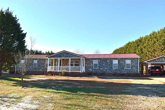 single story home featuring a carport, a front yard, and covered porch