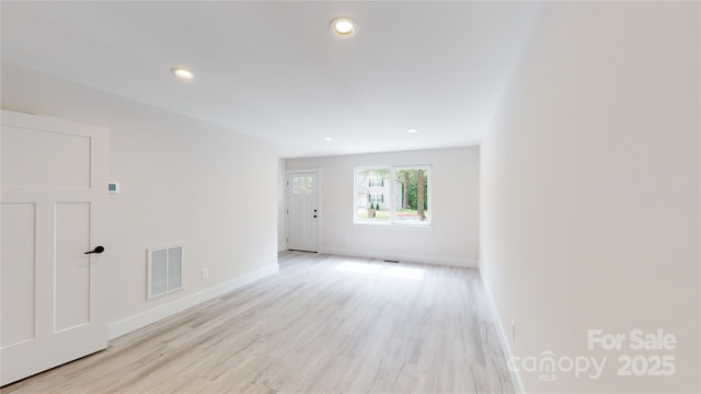 spare room featuring light wood-type flooring