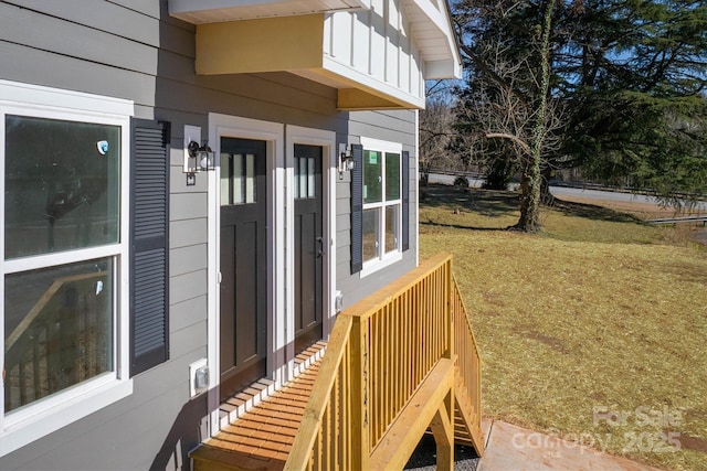 doorway to property featuring a yard