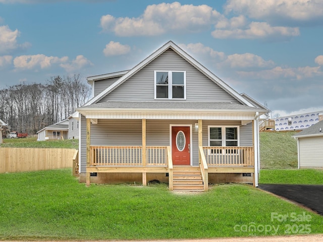 view of front of home with covered porch and a front yard