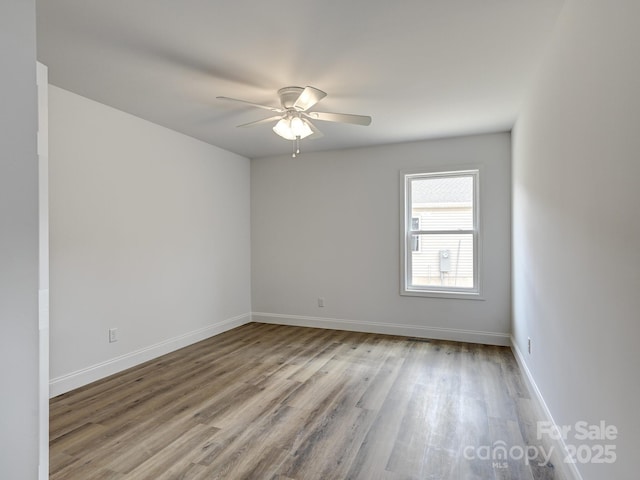 unfurnished room with ceiling fan and light wood-type flooring