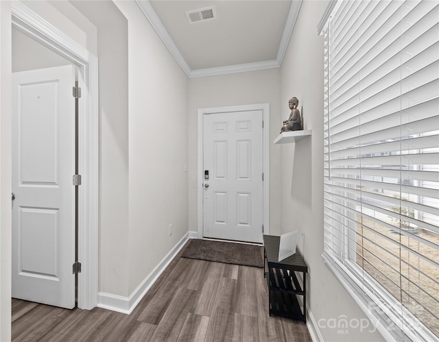 doorway to outside featuring hardwood / wood-style flooring and crown molding