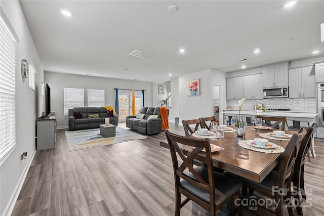 dining area featuring light wood-type flooring