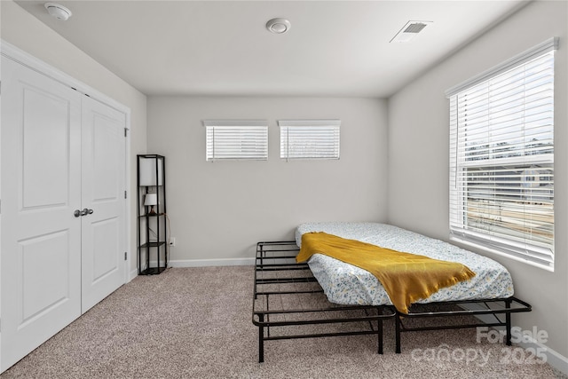 bedroom with a closet and carpet