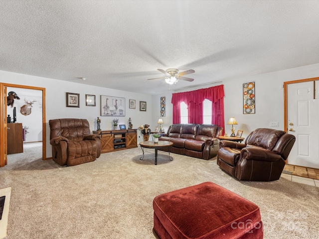 living room with ceiling fan, carpet, and a textured ceiling