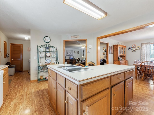 kitchen with a center island, light wood-type flooring, and electric cooktop