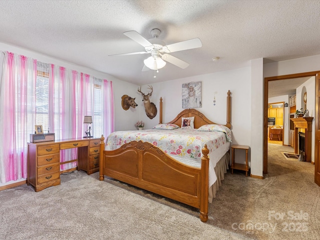 carpeted bedroom with ceiling fan and a textured ceiling