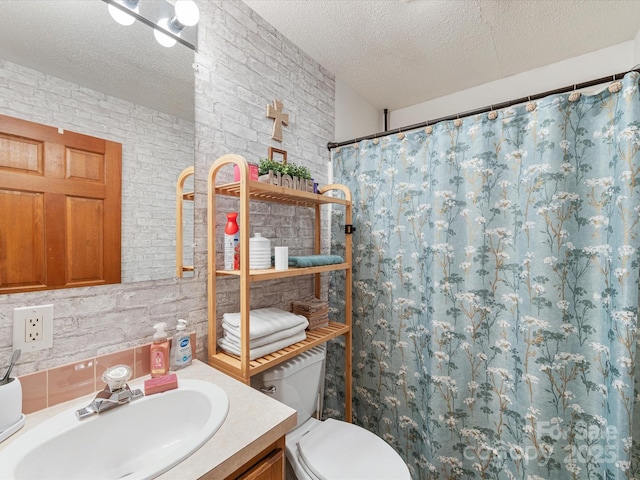 bathroom featuring brick wall, a textured ceiling, and a shower with curtain