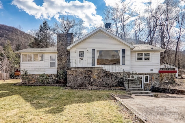 rear view of property with a lawn