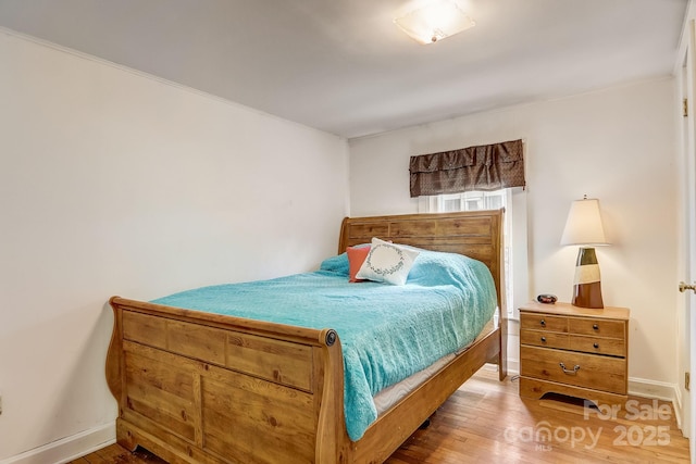 bedroom with wood-type flooring