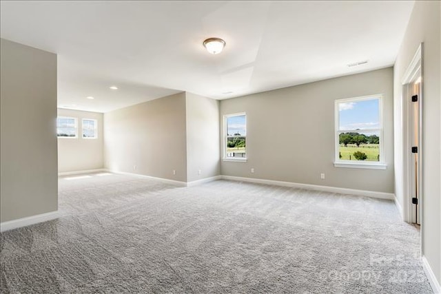 unfurnished room featuring light colored carpet