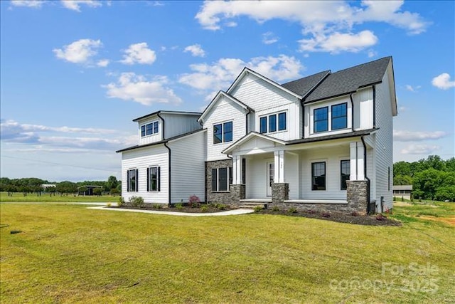 view of front of house with a porch and a front lawn