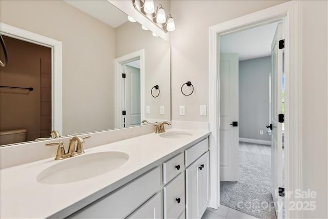 bathroom featuring tile patterned floors, vanity, and toilet