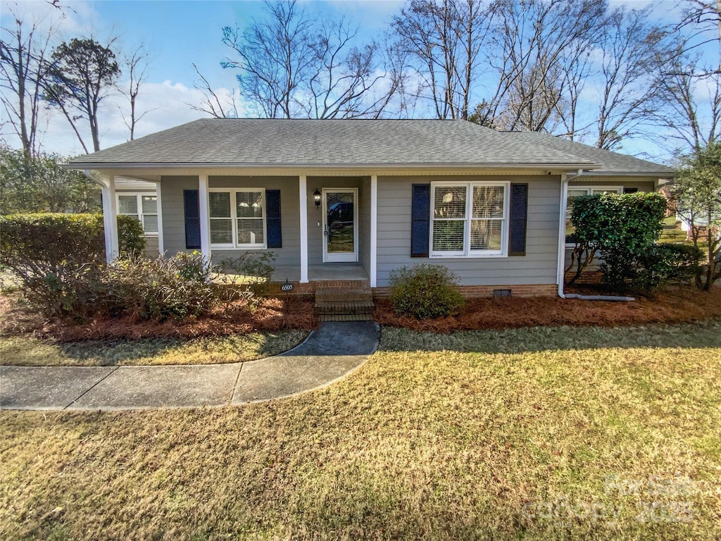 ranch-style house with a front yard and a porch