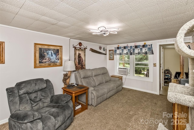 living room featuring cooling unit, crown molding, and carpet flooring