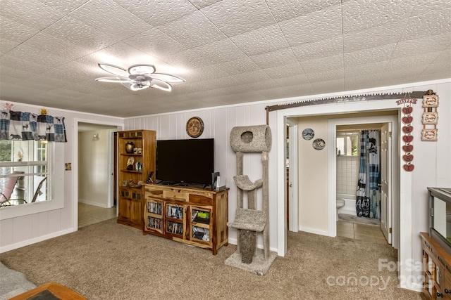 living room featuring carpet flooring and a healthy amount of sunlight