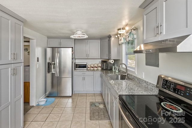 kitchen with sink, gray cabinets, light tile patterned floors, and appliances with stainless steel finishes