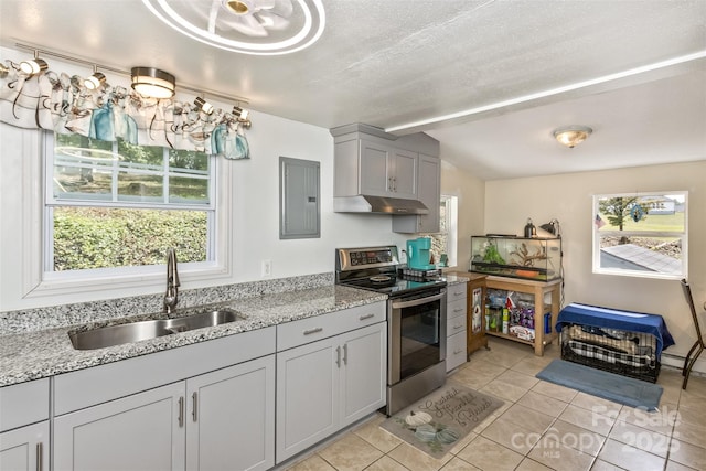 kitchen featuring light stone counters, light tile patterned floors, electric range, gray cabinets, and sink