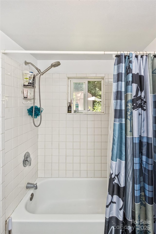 bathroom featuring shower / tub combo with curtain