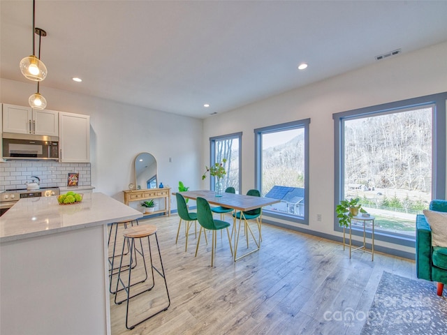 dining space with light hardwood / wood-style floors