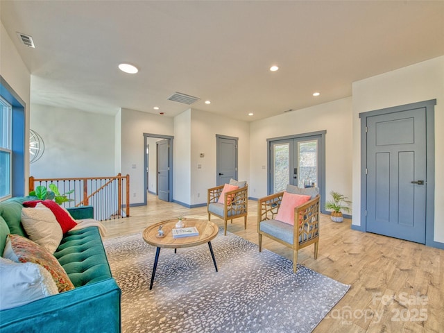 living room with french doors and light hardwood / wood-style floors