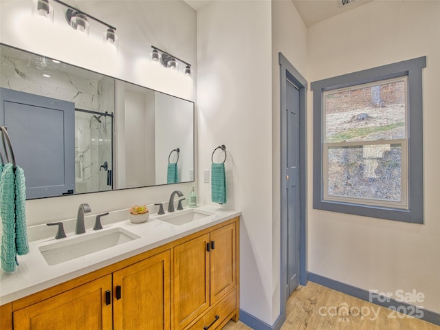 bathroom with vanity, hardwood / wood-style floors, and walk in shower