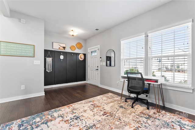 home office with dark hardwood / wood-style floors