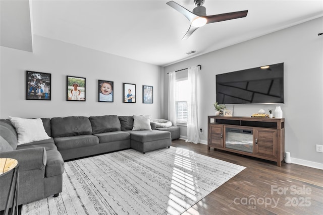 living room featuring ceiling fan and hardwood / wood-style flooring