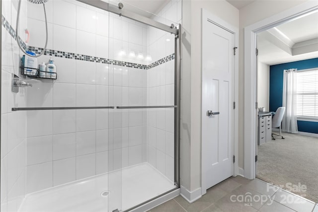 bathroom with walk in shower and tile patterned flooring