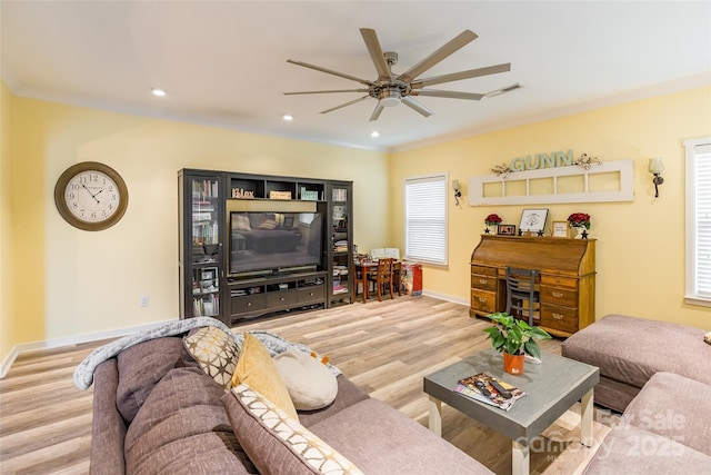 living room featuring hardwood / wood-style flooring, ceiling fan, and ornamental molding