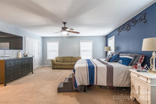 carpeted bedroom with ceiling fan