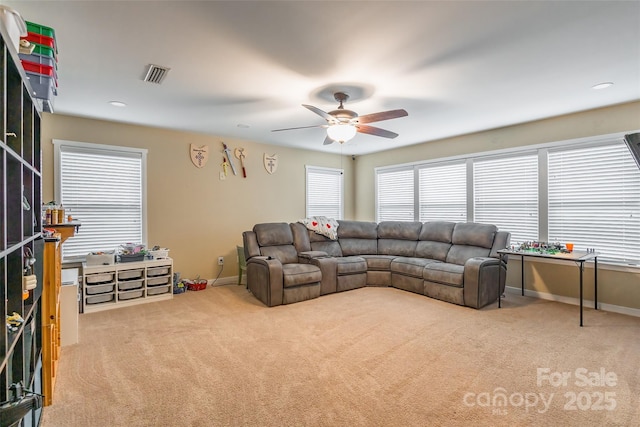 living room featuring ceiling fan and carpet