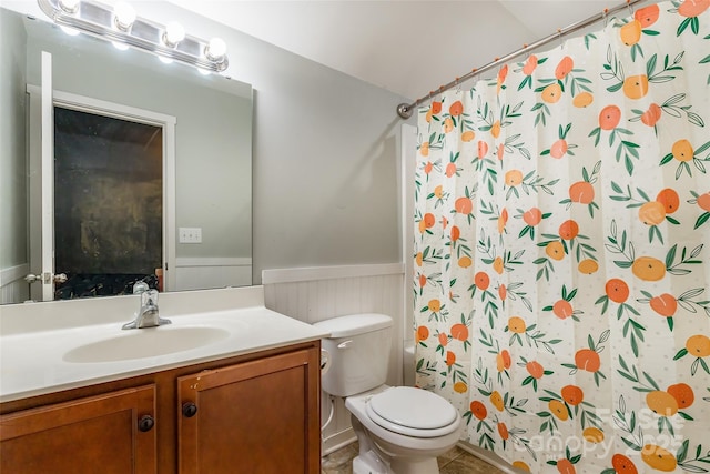 bathroom with tile patterned floors, vanity, toilet, and curtained shower