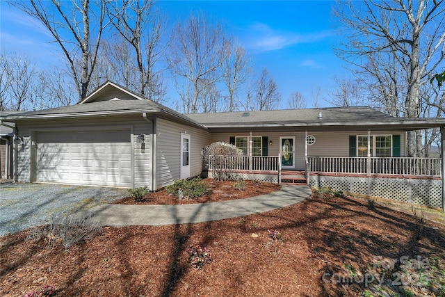 ranch-style house featuring covered porch, a garage, and gravel driveway