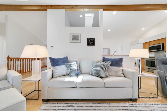 living room with light wood-style floors and recessed lighting