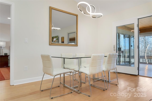 dining room featuring wood finished floors and baseboards