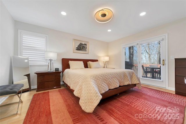 bedroom with access to exterior, recessed lighting, wood finished floors, and baseboards