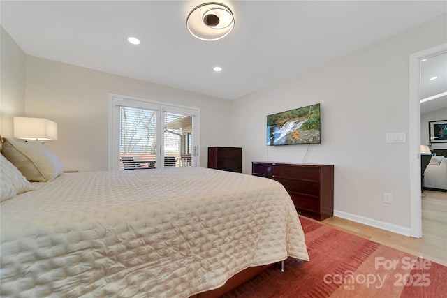 bedroom with wood finished floors, recessed lighting, and baseboards