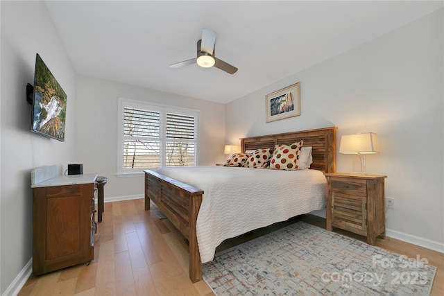 bedroom featuring light wood-style floors, baseboards, and a ceiling fan
