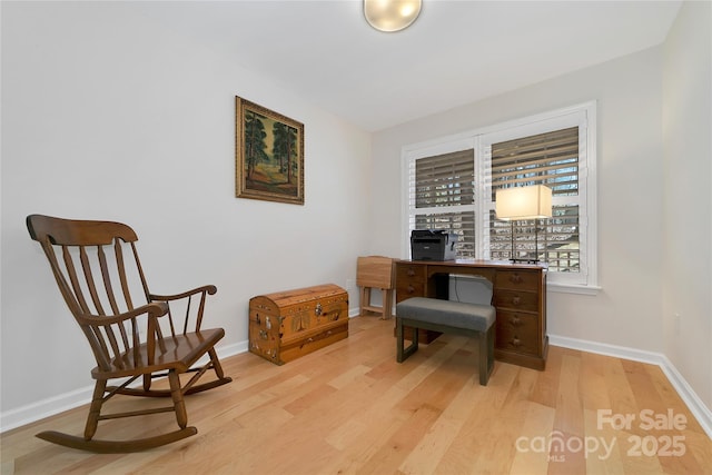 office area featuring light wood-style flooring and baseboards
