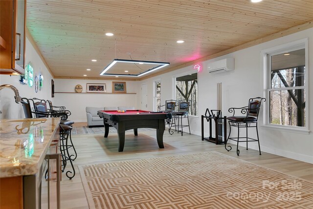 recreation room with billiards, wood ceiling, a wall mounted AC, healthy amount of natural light, and light wood-type flooring