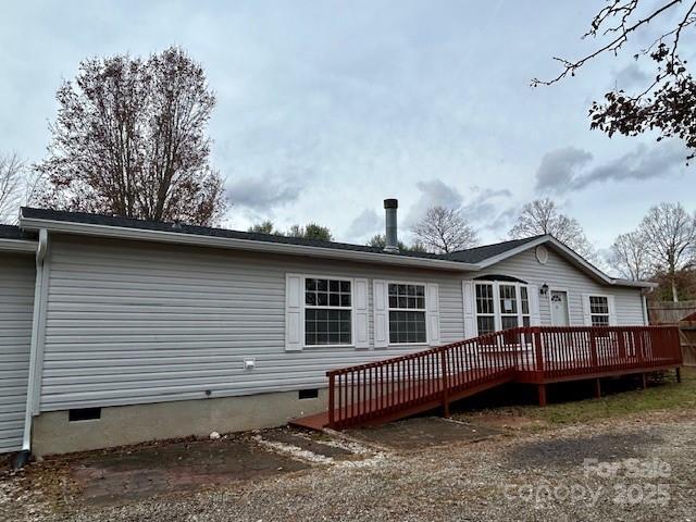 rear view of property with a deck and french doors