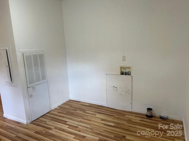 clothes washing area featuring washer hookup and light wood-type flooring