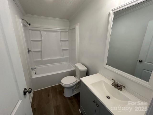 full bathroom with hardwood / wood-style floors, toilet, tub / shower combination, vanity, and a textured ceiling