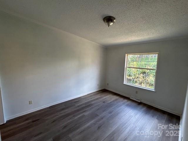 spare room with a textured ceiling and dark wood-type flooring