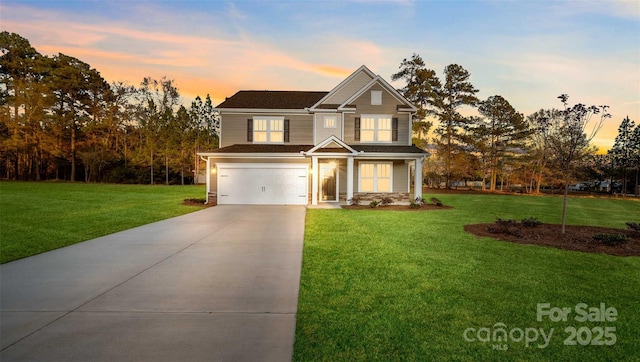 craftsman inspired home with a garage and a lawn